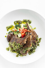 grilled organic lamb chops meal with chimichurri sauce in argentina