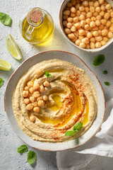 Delicious and homemade hummus with lime and mint leaves.