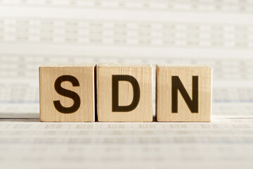 Wooden cubes with word SDN - abbreviation Software Defined Networking on white background.