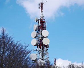 Antenna with repeaters and satellite dishes in a mountainous area