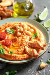 Traditional and delicious tomato hummus as healthy and quick snack.