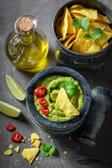 Tasty and homemade guacamole as a spicy mexican appetizer.
