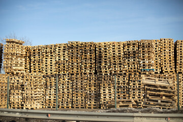 Lots of pallets. Warehouse of wooden pallets. Boarding.