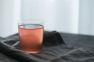 Berry lemonade in tumbler glass on linen cloth