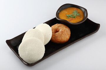 South Indian Breakfast menu, Idly Vadai with coconut chutney and sambar, served in a black tray