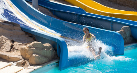little girl on a slide in a water park