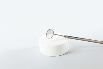 Dental mirror on a light background. Flat lay.Top view.Copy space.