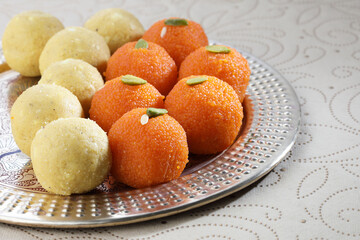 Diwali Sweets besan and motichur Laddu Indian traditional sweet served in a decorative golden plate