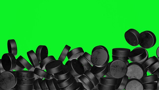 Many hockey pucks falling down on chromakey background. Hockey sport concept.	
