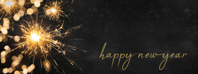 Silvester Party New year, new year's eve background banner panorama long, holiday greeting card - Sparklers and bokeh lights on dark night texture, with space for text