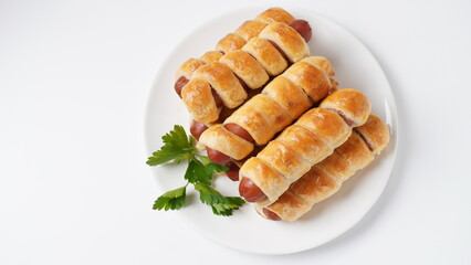 Sausage buns. Soft baked bun (dough )stuffed with sausage for fast food breakfast or coffee break. Sausage  roll, (hot dog).