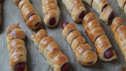 Sausage buns. Soft baked bun (dough )stuffed with sausage for fast food breakfast or coffee break. Sausage  roll, (hot dog).