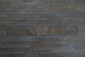Elegant stone cladding wall made of gray granite with different shades