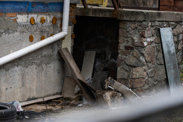 War in Ukraine. Damaged residential buildings. devastation in the yard.