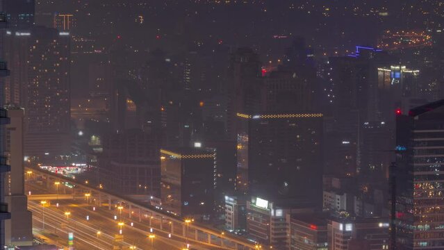 Dubai Aerial view showing al barsha heights and greens district area night timelapse