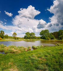 Picturesque countryside view with lake on a sunny day.