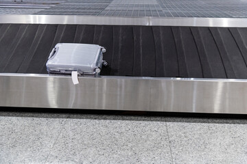 Single suitcase on conveyor belt at the airport