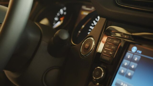 Starting car engine. Track in to the button. Finger press the button to start the car engine. Concept of transportation and technology. Pressing the button to start the car engine