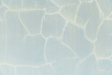 Old white wall with cracks