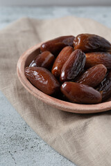 Algerian dates deglet nour on a light background in a bowl