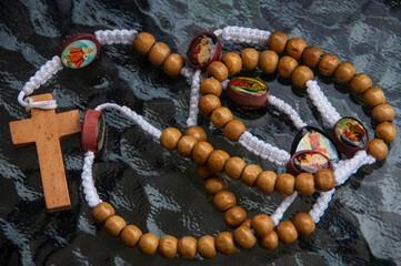 Holy Rosary on wooden table. Religious concept