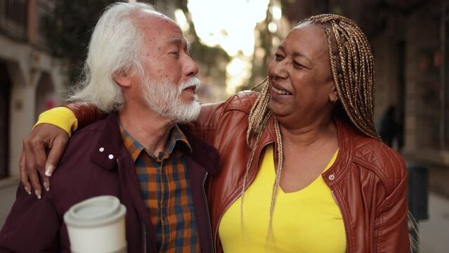 Multiracial senior couple having fun outdoor - Travel, elderly people concept