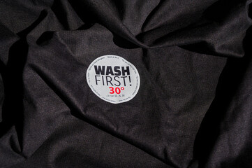 Sticker on a T-shirt with washing instructions and the text 