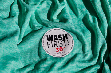 Sticker on a T-shirt with washing instructions and the text 