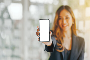 Mockup image of a beautiful brunette Asian woman shows mobile phone with blank white screen.