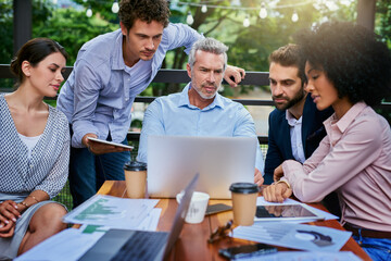 Out of office but still plugged into productivity. Shot of a group of colleagues having a meeting at a cafe.