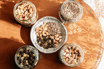 Cashew nuts, pistachios, sunflower seeds and pumpkin seeds in a glass jars bowl