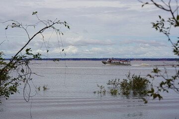 The usual form of transport in Amazon region of Brazil, where there are few roads. Here a speedboat...