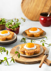 Fresh baked sweet flower shaped cakes with apricot, icing and chopped almond nuts. Homemade Easter food concept. Copy space.