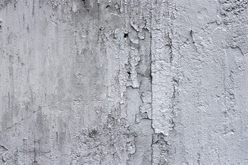 Rough texture of a concrete wall with peeling old paint