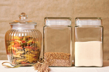 Colorful Italian pasta, buckwheat, semolina, grains on the traditional kitchen. Rural food and cooking background template