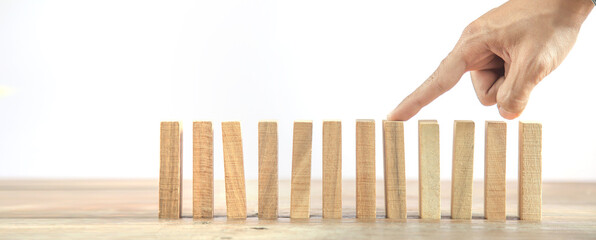 Hand prevent wooden block tower stack crash or fall domino. concept of prevention of financial...
