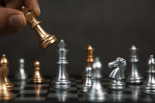 Hand choose king chess fight on chessboard concept of team player or business team and leadership strategy and human resources organization management or goal to win or strong winner.