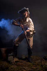 Fototapeta premium Pirate filibuster sea robber in suit with gun and saber. Concept photo