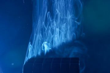 Smoke photographed in the studio with copy space and effect background