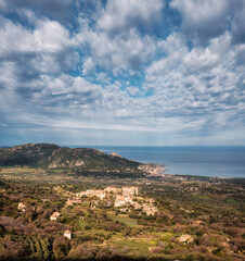 Fototapeta na wymiar Hilltop village of Pigna in the Balagne region of Corsica with Mediterranean sea in the distance