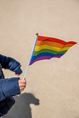 holding gay pride symbol rainbow flag