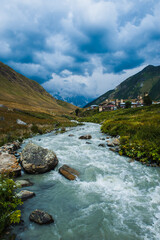 Village Ushguli landscape with massive rocky mountains