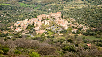 Fototapeta na wymiar Hilltop village of Pigna in the Balagne region of Corsica with Mediterranean sea in the distance