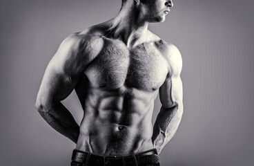 Torso with six pack and ab muscle. Abs and biceps. Strong brutal guy. Sexy torso. Handsome big muscles man posing at studio. Muscular sexy man. Handsome sexual strong man with muscular body