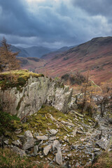 Stunning colorful Autumn landscape image of view from Castle Crag towards High Stile and Glaramara in Lake District