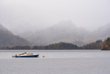 Stunning vibrant long exposure landscape image of Derwentwater looking towards Castle Crag peak in Autumn during early morning