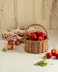 Fototapeta na wymiar Wicker basket with ranetki fruits (mini apples).