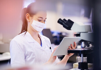 Modern tech for a lab tech. Shot of a young scientist using a digital tablet while working in a laboratory.