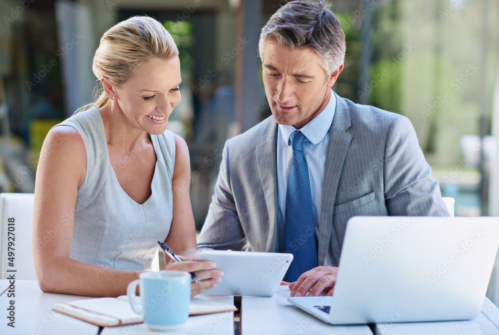 Canvas Prints Doing business in 4g. Shot of two mature businesspeople talking together of a tablet and laptop.