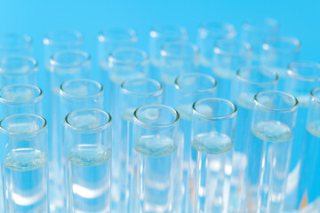 Test tubes with liquid on blue background